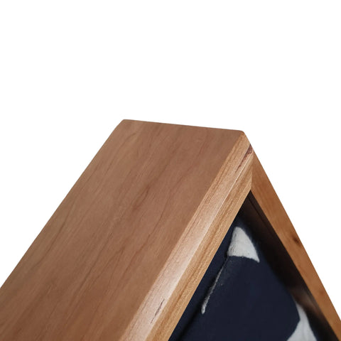 Close-up of the Cherry Burial Flag Display Case (5 X 9.5 Flag) by Legacies of America Woodworking Company, showing folded dark blue fabric with white markings against a plain white background.