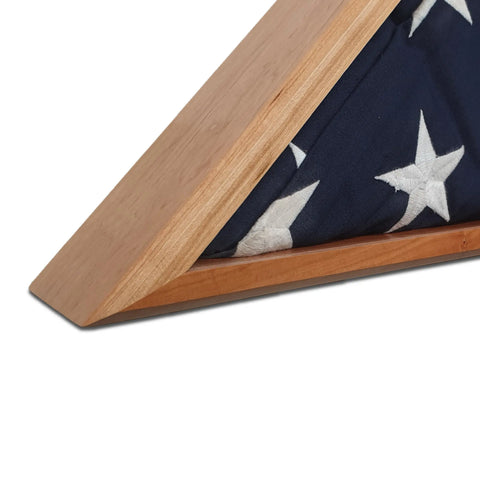 A close-up of a folded American flag with white stars in the Legacies of America Woodworking Companys Cherry Burial Flag Display Case (for 5 x 9.5 flags), set against a white background.