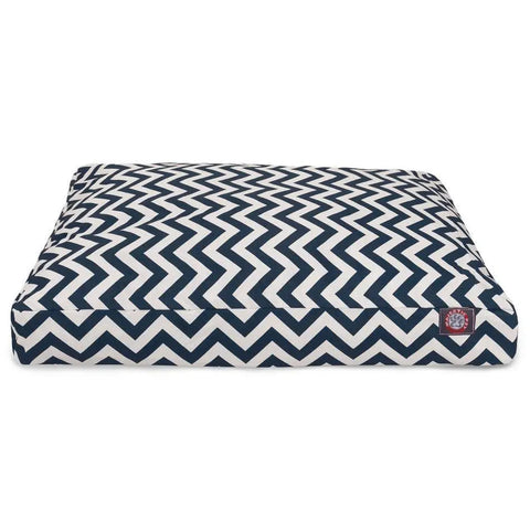 The Majestic Pet Chevron Rectangle Dog Bed features a navy blue and white zigzag pattern, a small red and white logo patch on one corner, and a washable cover for easy cleaning.