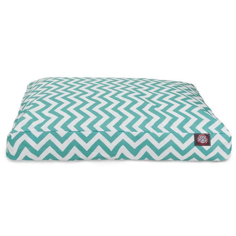 The Majestic Pet Chevron Rectangle Dog Bed features a teal and white zigzag chevron pattern, a paw print tag, and plush polyester fill for comfort. Thick and cushioned, its an inviting spot for your pet to relax.