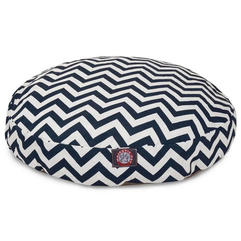 The Majestic Pet Chevron Round Dog Bed features a black and white zigzag pattern, a small red logo tag on the front, and a removable cover for easy cleaning.
