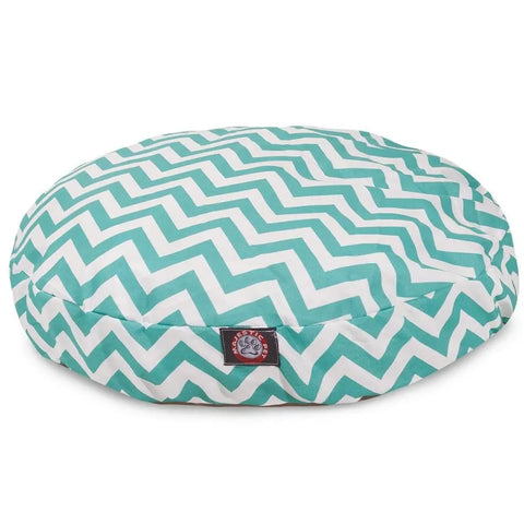 The Majestic Pet Chevron Round Dog Bed features a teal and white chevron pattern, a small black paw print logo patch, and a removable washable cover for easy cleaning.