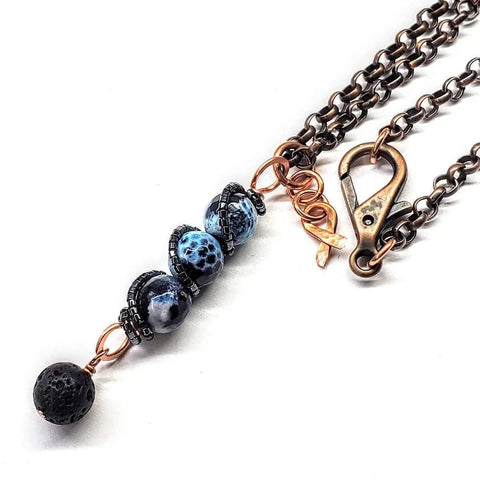 The Alexa Martha Designs Child Abuse Prevention Awareness Beaded Gemstone Stick Pendant With Lava Rock Bead Charm Necklace features a copper chain, lobster clasp, and four stacked black and blue beads—ideal for essential oil jewelry.