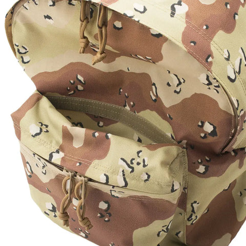 A close-up of the MIS Daypack - Chocochip Desert Camo shows its water-resistant packcloth nylon, main compartment, and front pocket, both featuring tan zipper pulls.