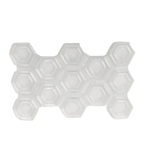 The Chatelet Manufacturing Clear Snowboard Stomp Pad features hexagonal compartments in a honeycomb pattern for better grip and adhesion. This empty, durable plastic pad is shown from above on a white background.