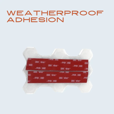 The Chatelet Manufacturing Clear Snowboard Stomp Pad features a hexagon pattern for improved grip and adhesion. Durable plastic with two red 3M adhesive strips sits on a light background under bold orange WEATHERPROOF ADHESION text.