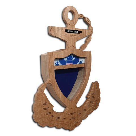 The Coast Guard Chief Petty Officer (CPO) Anchor Shadow Box by Legacies of America Woodworking Company is a wooden plaque featuring an engraved anchor, blue shield, and a section with a REDACTED label near the top.