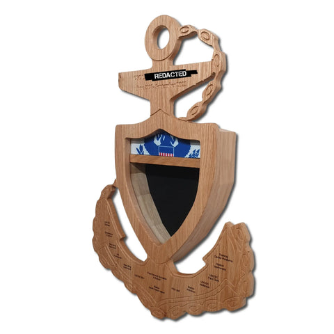 The Coast Guard Chief Petty Officer Anchor Shadow Box by Legacies of America Woodworking Company features a handcrafted hardwood anchor with a central shield, black label on top, engraved names below, and blue and white detail inside the shield.