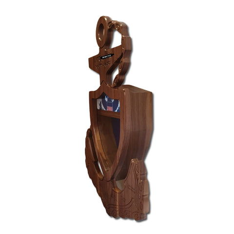 The Legacies of America Woodworking Company Coast Guard Chief Petty Officer (CPO) Anchor Shadow Box is a wooden shield-shaped display case with a circular top, intricate carvings, and a folded American flag inside, set against a plain white background.
