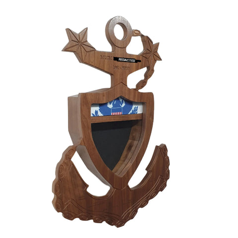 The Coast Guard Master Chief Petty Officer (MCPO) Anchor Shadow Box by Legacies of America Woodworking Company is a USA-made wooden anchor and shield display with engraved stars, a patriotic shelf, and a nameplate with redacted text.