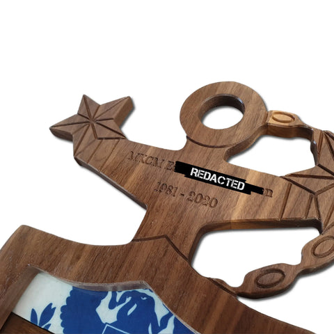 A close-up of the Coast Guard Master Chief Petty Officer (MCPO) Anchor Shadow Box by Legacies of America Woodworking Company, crafted from fine hardwoods in the USA, displaying years 1981-2020 and a partial blue and white emblem at the bottom.