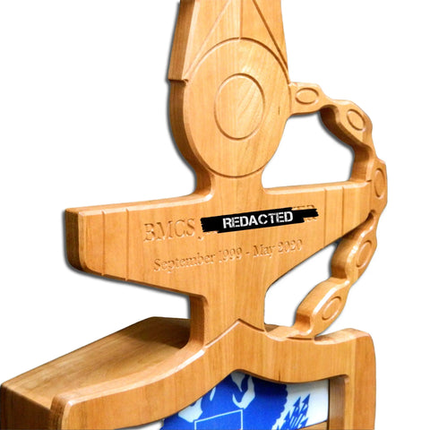 A close-up of the Coast Guard Senior Chief Petty Officer (SCPO) Anchor Shadow Box by Legacies of America Woodworking Company, crafted from fine hardwoods by veterans, resting on a white background with a blue emblem partially visible.
