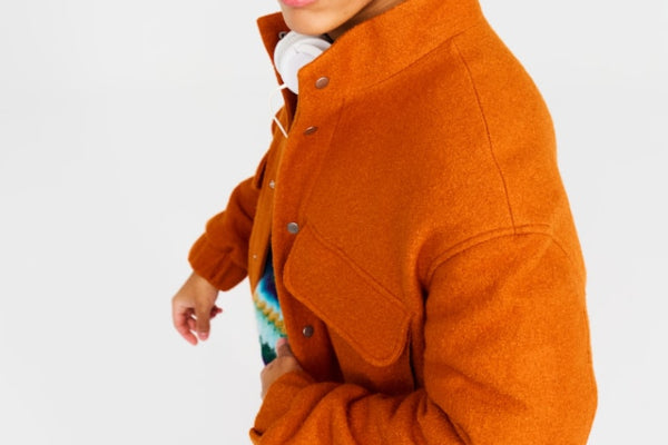 Person wearing an orange jacket on a white background