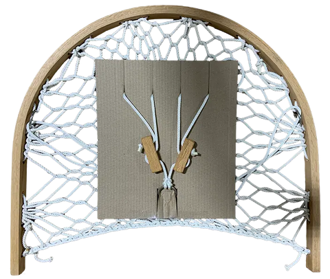The Cobble Mountain Summit Foothold is a handmade weaving loom featuring a semicircular wooden frame, white knotted cord net, a central square cardboard piece, and two wooden-handled tools—ideal for hammock chair repairs or as an accessory.