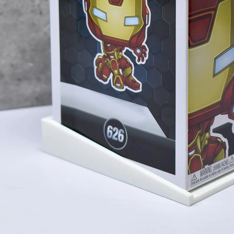 A close-up shows a Funko Pop! Iron Man box (#626) displayed in a Chatelet Manufacturing Collectible Wall Display Stand, perfect for showcasing original boxed figures on your wall. Made in the USA and compatible with Funko Pop figures in box.