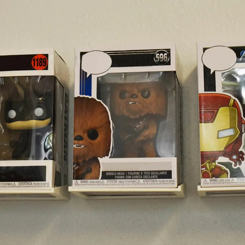 Three Funko Pop! figures—Batman (#1189), Chewbacca (#596), and Iron Man—are showcased in their boxes on Chatelet Manufacturing’s Collectible Wall Display Stands, keeping each figure visible and the boxes safely displayed on your wall.