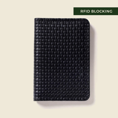 The CASUPO Compact Bifold With RFID Protection - Black Limited Edition, featuring a textured woven pattern, rests on a light background. A green and white label at the top right says RFID BLOCKING.