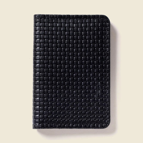 The CASUPO Compact Bifold With RFID Protection - Black Limited Edition is a sleek, minimalist wallet with rounded corners and a textured checkerboard leather design, shown against a plain light beige background.