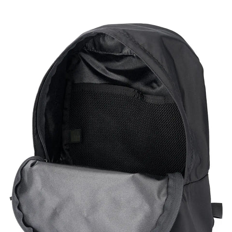 A close-up of the MIS Daypack S - Black, made in the USA, displays the interior lining and mesh pocket inside its main compartment.