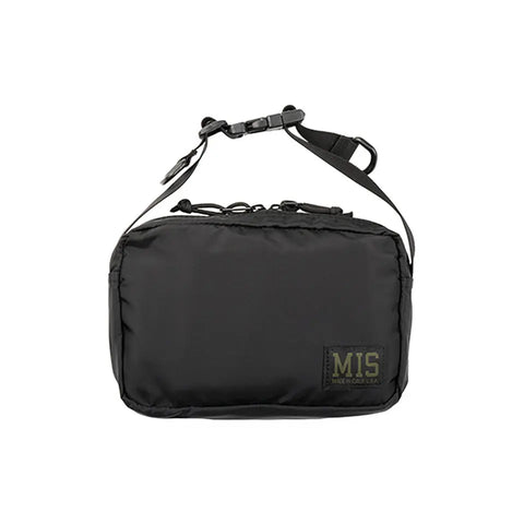 The MIS AW Shoulder Bag S in black features a rectangular packcloth nylon build, zippered top, adjustable shoulder strap, water-resistant design, and a patch label with MIS on the bottom right corner for a simple, utilitarian look.