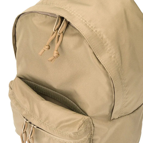 A close-up of the MIS Daypack S in Coyote Tan, made in the USA, highlights its water-resistant material, top zipper with dual knotted pull strings, and a partially open front pocket.