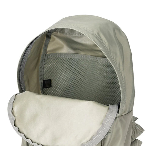 A close-up of the open top compartment of the MIS Daypack S - Foliage in light gray water-resistant nylon, showing an empty mesh pocket inside and part of the open flap.