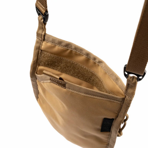 A close-up of the MIS Shoulder Pouch Gen2 in Coyote features an open top, inner pocket, and adjustable strap with a black buckle. Its minimalist design and durable fabric provide secure daily storage.