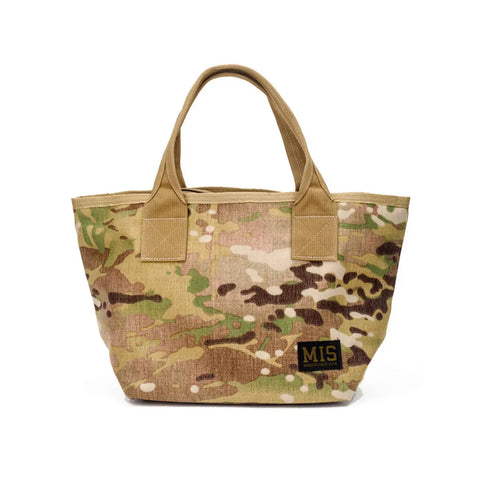 The MIS Mini Tote Bag - Multi Cam features a water-resistant camouflage Cordura nylon, tan handles, and a black MIS patch on the lower right front—made in the USA for lasting durability.