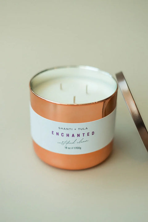 The Copper Vessel 3-Wick Soy Candle by Shanti + Tula, a clean-burning, USA-made candle with a sleek design and white wax, sits open to reveal its three unlit wicks. This luxury decor piece is perfect as a sophisticated, gift-ready accent.