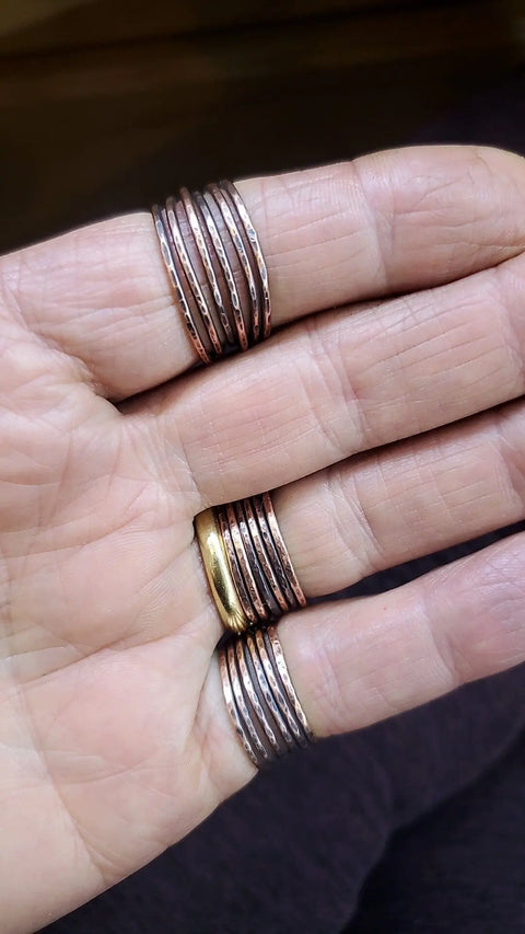 A hand adorned with the Copper Wire Wrapped Crystal Heart Glam Ring by Alexa Martha from Alexa Martha Designs.
