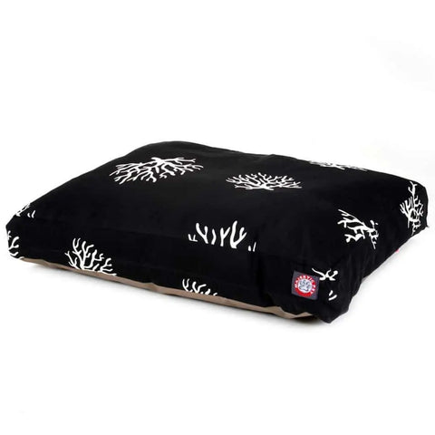 The Coral Rectangle Dog Bed by Majestic Pet features a black cushion with a white coral pattern, a small red and white logo tag, and a removable, washable cover, shown on a white background.