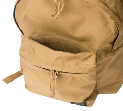A close-up of the MIS Daypack Cordura in Coyote Brown shows a front zipper pocket, drawstring pulls, and one shoulder strap. Made in the USA, its an 18L laptop backpack ideal for daily use.