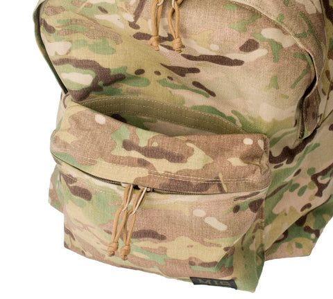 A close-up of the MIS Daypack Cordura - Multi Cam shows its durable, water-resistant Cordura Nylon, zippered front pocket with tan pulls, and a glimpse of the spacious main compartment.