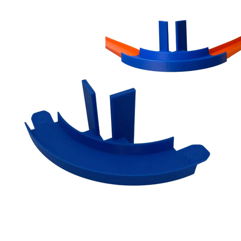 The Chatelet Manufacturing Corner Wall Mount Track is a blue plastic 90-degree turn with two upright partitions, compatible with Hot Wheels, featuring removable adhesive for easy wall mounting. Made in the USA—perfect for upgrading your racing setup.