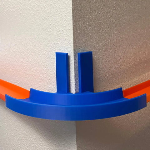 The Chatelet Manufacturing Corner Wall Mount Track, compatible with Hot Wheels, features a 90-degree turn and removable adhesive for easy mounting to walls, connecting two tracks for exciting racing fun. Made in the USA.