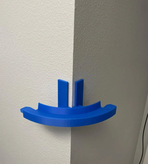 The Chatelet Manufacturing Corner Wall Mount Track, compatible with Hot Wheels, features a 90-degree turn and removable adhesive for easy mounting in any corner—perfect for endless racing on two white walls. Made in the USA.