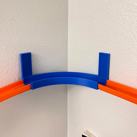 The Chatelet Manufacturing Corner Wall Mount Track offers a 90-degree turn for Hot Wheels tracks, with removable adhesive for easy wall mounting—perfect for exciting racing action around room corners. Made in the USA.
