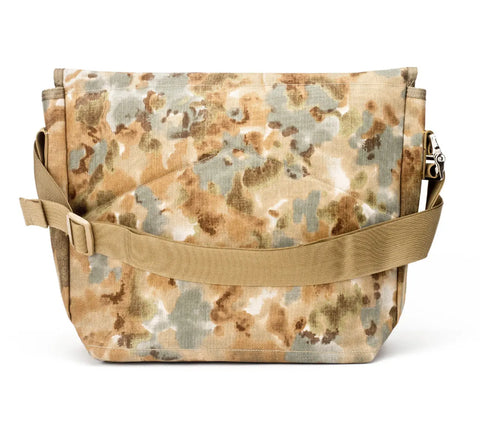 The MIS Messenger Bag - Covert Desert features durable Cordura Nylon in tan and green camo, a wide adjustable shoulder strap, a front diagonal seam pocket, and waterproof protection—ideal for daily use.