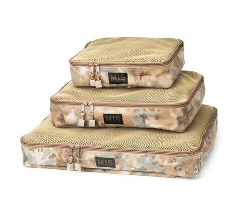 The MIS Organizer Set - Covert Desert features three stacked camouflage packing cubes made of durable Cordura nylon with mesh tops and zippers. This travel organizer set is proudly made in the USA and shown on a white background.