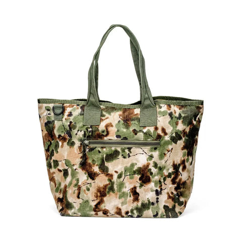 The MIS Tote Bag - Covert Woodland is a large Cordura Nylon tote with green handles, woodland camo print, and a front zippered pocket featuring a heavy-duty zipper.