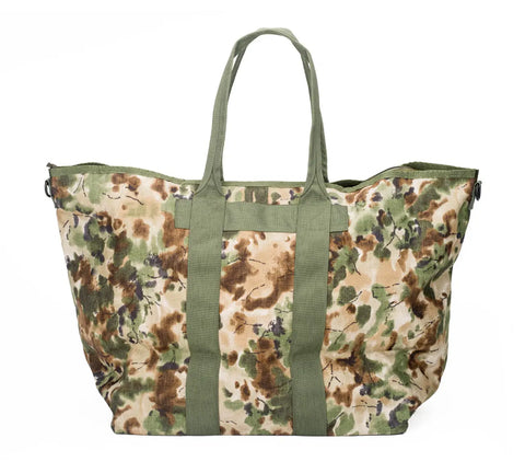 The MIS Super Tote Bag - Covert Woodland is a large, water-resistant tote with green handles and a green, brown, and tan camouflage Cordura Nylon design, shown against a white background for lasting durability.