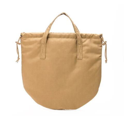 The MIS UK Helmet Bag in Coyote Brown is made from durable, water-resistant 500D Cordura Nylon. It features short handles, a rounded bottom, and drawstring details on both sides, shown against a white background.