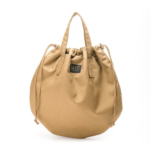 The MIS UK Helmet Bag in Coyote Brown is made in the USA from durable 500D Cordura Nylon, featuring two handles, a drawstring closure, and a small black MIS label on the front.