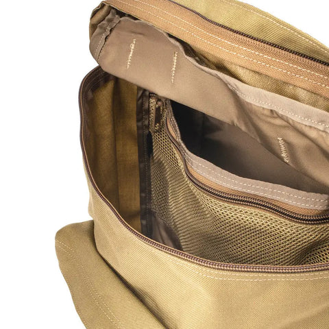 Close-up view of the MIS Backpack - Coyote Tan, featuring a zippered main compartment, mesh inner pocket, padded laptop holder, and fabric dividers. The durable bag is empty and showcases its organized interior.