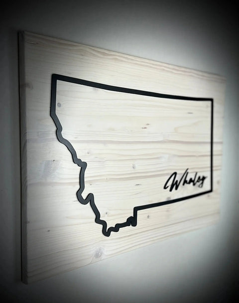 The Large Rectangle Personalized MT Sign by B. James Design & Woodwork features a black Montana outline with a signature-style Whaley on light wood, offering unique custom decor and available in personalized colors.