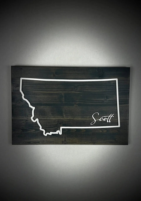 The Large Rectangle Personalized MT Sign by B. James Design & Woodwork showcases Montanas outline with the name Scott in script on a dark wood background—ideal custom decor for any space.