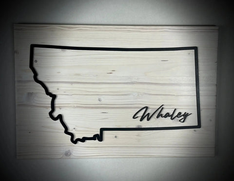 The Large Rectangle Personalized MT Sign by B. James Design & Woodwork features a wooden outline of Montana with Whaley in script on the lower right, available in custom colors—perfect personalized décor.