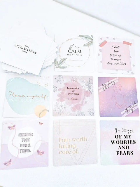 The Shanti + Tula Daily Affirmation Card Deck features nine pastel mindfulness cards with uplifting messages like I am calm and at peace and I am worthy of everything I desire, thoughtfully arranged on a white surface. Made in USA.