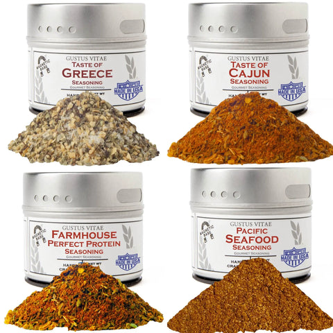 The Deluxe Land & Sea Grilling Collection | Set of 4 by vendor-unknown features a tin each of Taste of Greece, Taste of Cajun, Farmhouse Perfect Protein, and Pacific Seafood gourmet seasonings, displayed with piles of their all-natural spice blends.