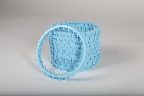 The Dentapup Dog Dental Toy by Dentapup features a blue, cylindrical, woven basket-like design with a matching blue spiked oval ring, both made of plastic—ideal for promoting dog oral hygiene.